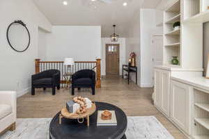 Living room with lofted ceiling and light wood-type flooring