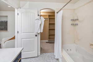 Bathroom featuring tile patterned floors, vanity, and shower / bath combo