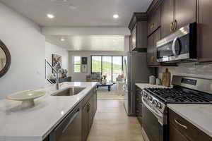 A stylish, contemporary kitchen featuring a generous island, perfect for hosting and socializing with family and friends. The open-concept layout effortlessly transitions into the living space, making it an ideal setting for both dinner parties and casual