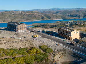 Birds eye view of property with a water and mountain view