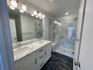 Bathroom featuring vanity and an enclosed shower