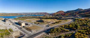 Drone / aerial view featuring a water and mountain view