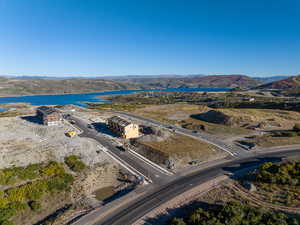 Birds eye view of property with a water and mountain view