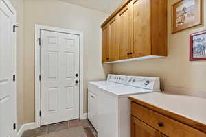 Laundry room featuring cabinets and washer and dryer