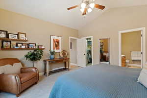 Bedroom with ensuite bath, light colored carpet, ceiling fan, a spacious closet, and a closet