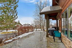 Snow covered patio featuring grilling area