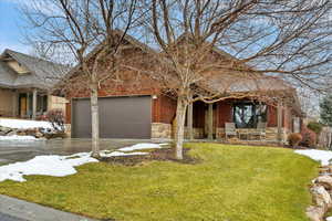 View of front of home featuring a garage and a front lawn