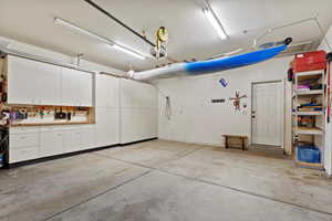 Garage featuring a workshop area and a garage door opener