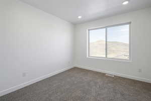 Carpeted empty room with a mountain view