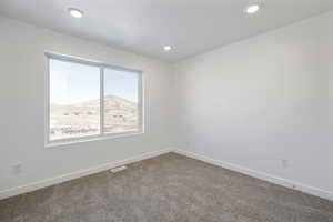 Carpeted spare room featuring a mountain view