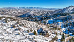 Snowy aerial view featuring a mountain view