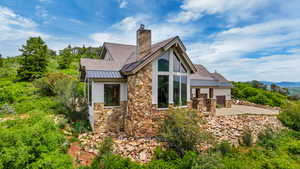 Rear view of property with an outdoor kitchen and a patio area