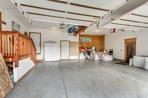 Garage featuring wood walls and a garage door opener