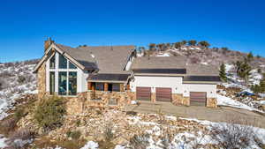 View of snow covered rear of property