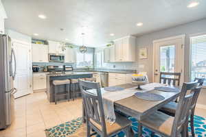 Tiled dining room with a textured ceiling and sink