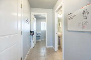 Hallway with light tile patterned floors