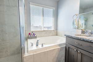 Bathroom with vanity and independent shower and bath