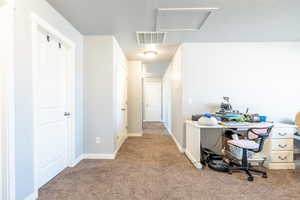 Home office featuring light colored carpet