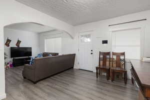 Living room featuring hardwood / wood-style floors and a textured ceiling