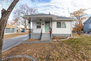 Bungalow-style home with a porch and a front yard