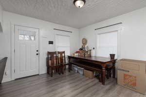 Foyer entrance with hardwood / wood-style floors and a textured ceiling