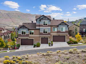 View of front of property with a mountain view and a garage