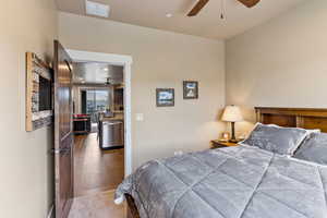 Bedroom featuring ceiling fan and hardwood / wood-style flooring