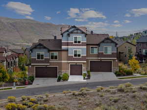 View of front of home featuring a mountain view and a garage