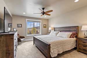 Carpeted bedroom with ceiling fan