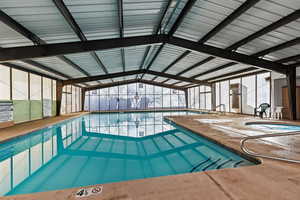 View of pool featuring a lanai, an indoor in ground hot tub, and a patio