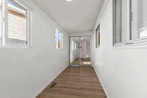 Bedroom featuring vinyl plank flooring and lofted ceiling