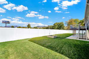 View of yard featuring a patio area and a deck with mountain view