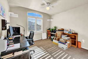 Carpeted office featuring ceiling fan and a textured ceiling