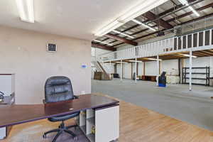 Home office with hardwood / wood-style flooring