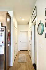 Hall featuring light wood-type flooring