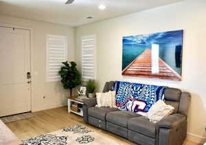 Living room featuring hardwood / wood-style flooring and ceiling fan