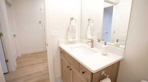 Bathroom featuring hardwood / wood-style flooring and vanity