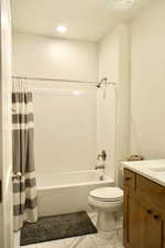 Full bathroom featuring shower / tub combo, vanity, and toilet