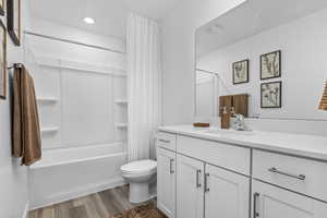 Full bathroom with toilet, vanity, bathtub / shower combination, and LVP flooring