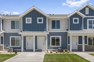 View of front facade with central AC and a front yard