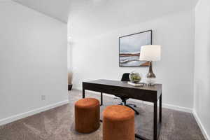 Home office with carpet floors and a textured ceiling