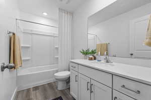 Full bathroom featuring washtub / shower combination, LVP flooring, and toilet