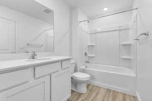 Full bathroom with vanity, shower / bath combination, toilet, and LVP floors