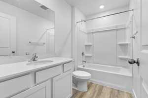 Full bathroom featuring LVP floors, vanity, toilet, and shower / washtub combination