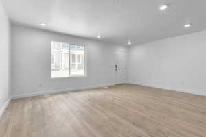 Spare room featuring a textured ceiling and laminate flooring