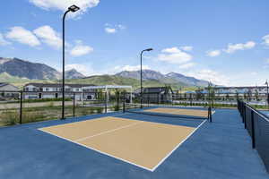 View of tennis court featuring a mountain view and basketball court