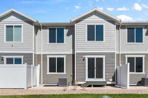 Rear view of property featuring central AC unit