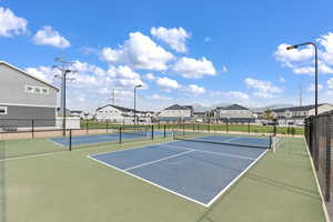 View of tennis court with basketball hoop