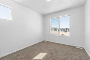 Unfurnished room with carpet flooring and a textured ceiling