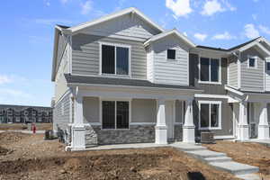 View of front of property featuring a porch and central air condition unit